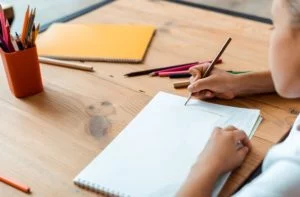 Kid drawing on a desk