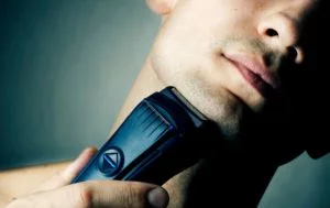 Man using a foil shaver to trim his beard
